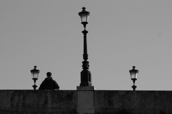 Tre lampioni e un uomo affacciato 