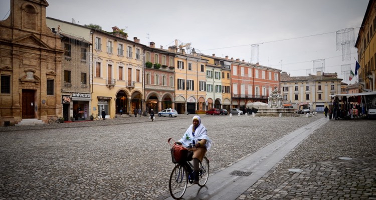 Donna in bicicletta in Piazza del Popolo, a Cesena