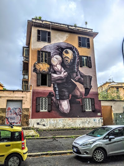 Roma insolita: murale che rappresenta due lottatori a Tor Marancia